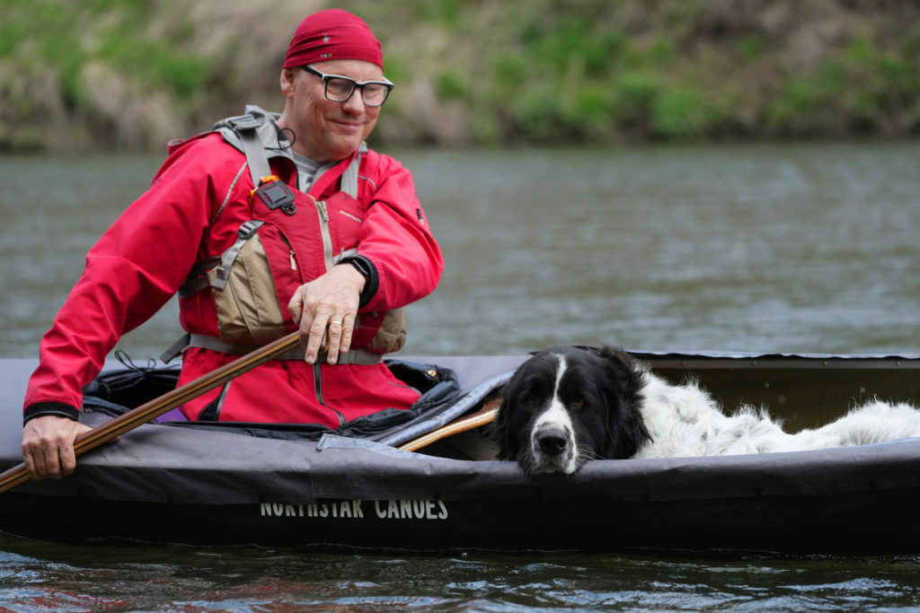 Dog resting in a canoe.